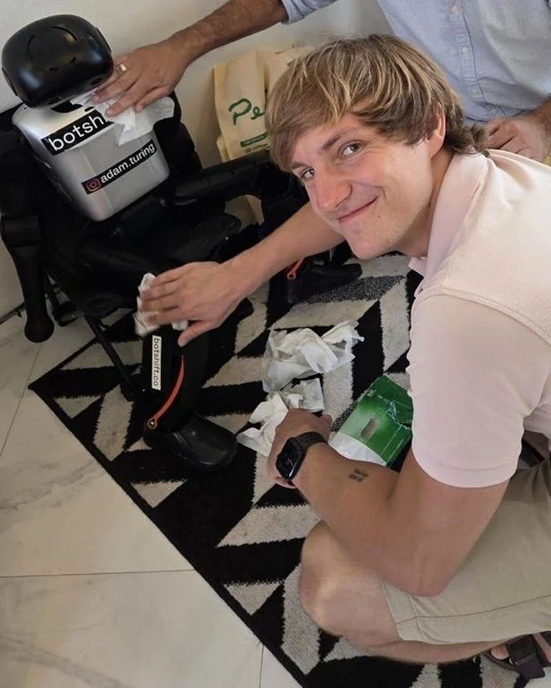 Bohdan Petryshyn beside a humanoid robot