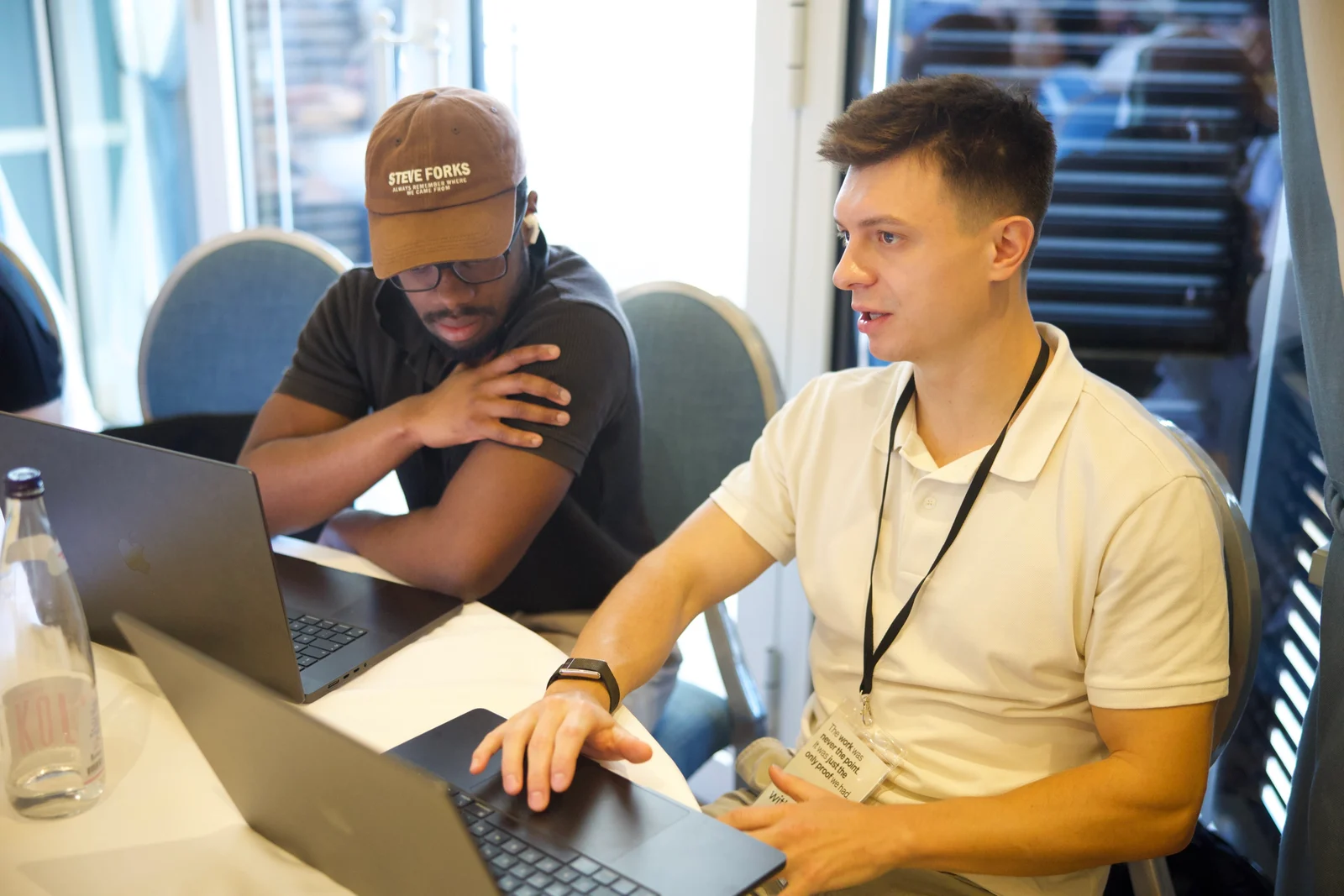 Bo working with an attendee on a laptop at a workshop